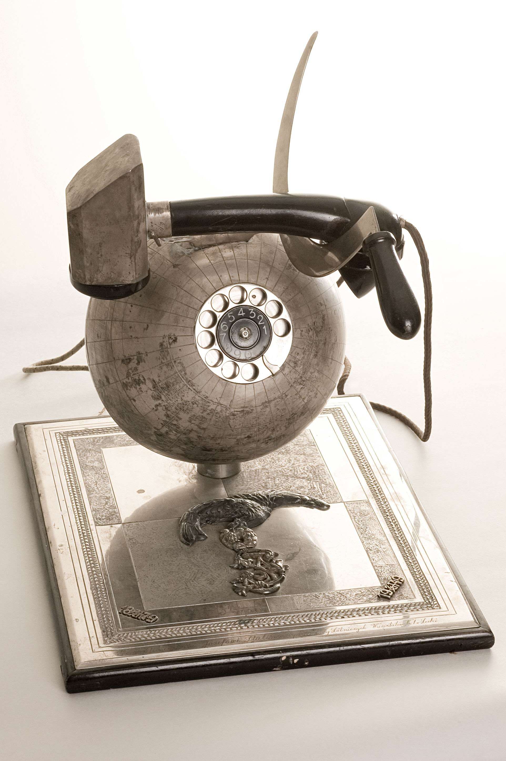 Telephone set in the form of the globe with receiver as a hammer and sickle A gift to J.V.Stalin for his 70th birthday from workers of the aircraft workshop No. 1.Lodz, Polish Republic, 1949. Metal, enamel, plastic and wood Courtesy of the State Central M